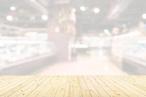 Empty wood table top with supermarket blurred background for product display photo