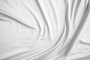 Abstract white wrinkled bedding sheet fabric texture background photo