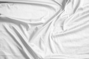 Abstract white wrinkled bedding sheet fabric texture background photo