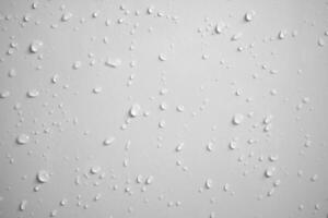 Water drops on white wall background texture photo
