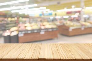 Empty wood table top with supermarket blurred background for product display photo
