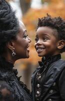 A young Black boy happily dressed as a vampire, smiling proudly at his mother photo