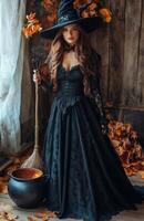 A stunning woman dressed as a witch holding a broom, standing beside a bubbling cauldron photo
