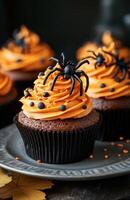 Halloween themed cupcakes with spider decorations are creatively arranged on a festive plate for display photo