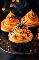 Halloween themed cupcakes with spider decorations are creatively arranged on a festive plate for display photo