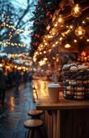 A cozy Christmas market stall offering steaming hot coffee, festive sweets, and holiday decorations photo