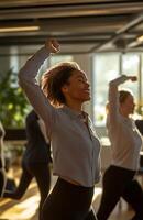 Office workers from different backgrounds engaged in group stretching exercises during a break photo