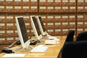 computer terminals in a modern library with blurred catalog cabinets in the background photo