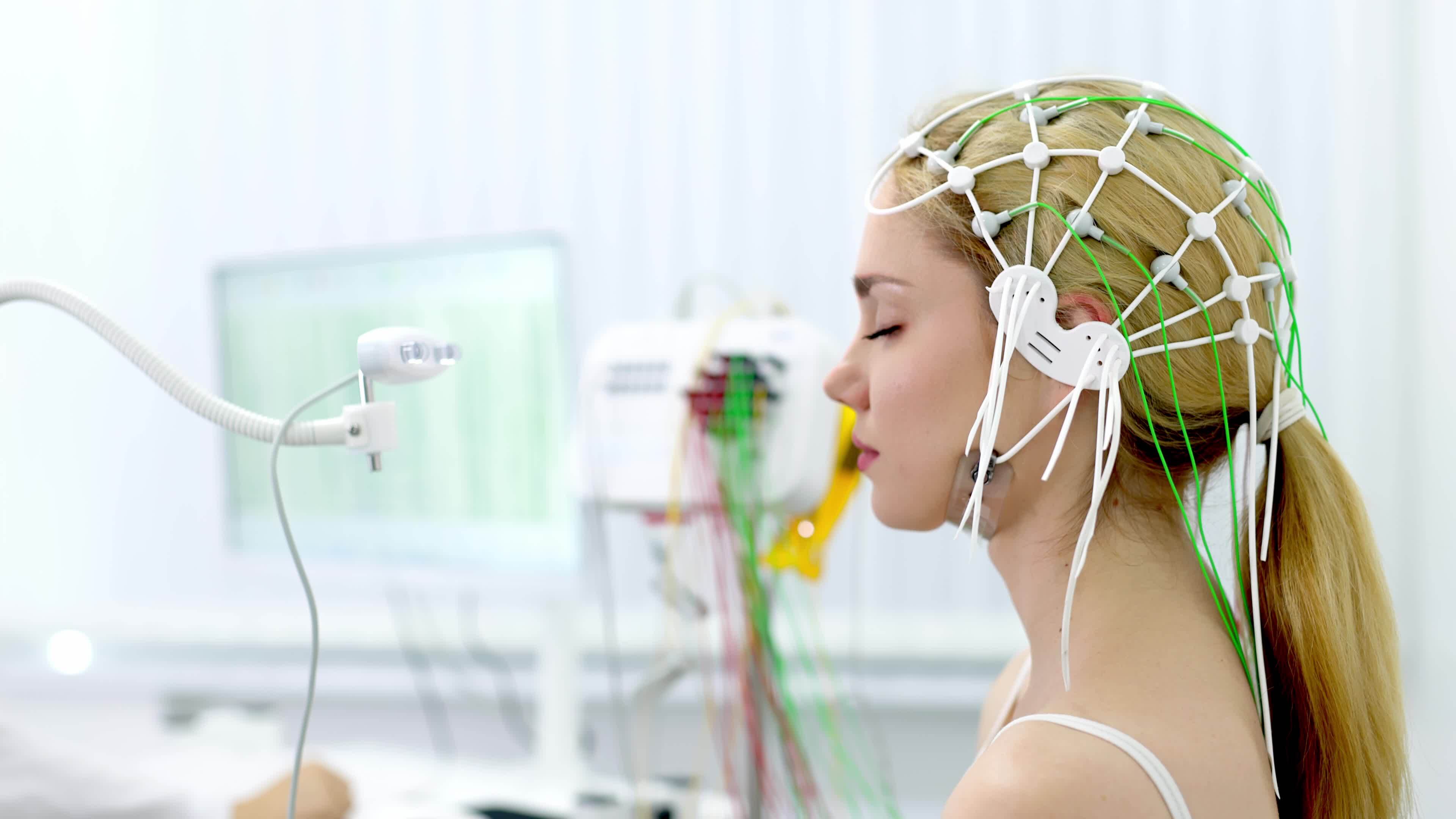 A young woman undergoes an EEG test in a modern clinic, showcasing
