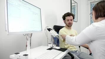 The patient undergoes an electromyography EMG test to assess nerve activity. Detects nerve and muscle dysfunctions. Perfect for showcasing advanced medical video