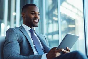 Close up of young businessman using digital tablet while sitting at his working place in office. Businessman using digital tablet photo