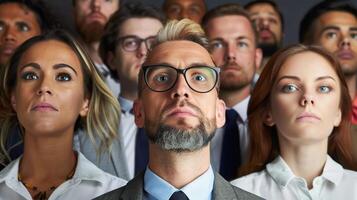 diverse group of people in their 40s looking attentively forward, dressed in professional attire photo