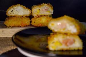 The Indonesian version of risoles is filled with mayonnaise, sausage, corn and boiled egg wrapped in a crepe-like wrapper and coated in breadcrumbs and deep-fried. selected focus. photo