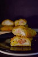 The Indonesian version of risoles is filled with mayonnaise, sausage, corn and boiled egg wrapped in a crepe-like wrapper and coated in breadcrumbs and deep-fried. selected focus. photo