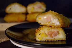 The Indonesian version of risoles is filled with mayonnaise, sausage, corn and boiled egg wrapped in a crepe-like wrapper and coated in breadcrumbs and deep-fried. selected focus. photo