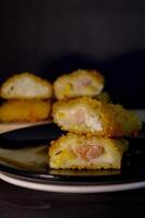 The Indonesian version of risoles is filled with mayonnaise, sausage, corn and boiled egg wrapped in a crepe-like wrapper and coated in breadcrumbs and deep-fried. selected focus. photo