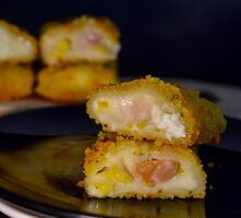 The Indonesian version of risoles is filled with mayonnaise, sausage, corn and boiled egg wrapped in a crepe-like wrapper and coated in breadcrumbs and deep-fried. selected focus. photo