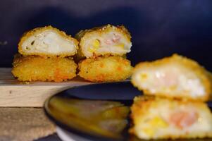 The Indonesian version of risoles is filled with mayonnaise, sausage, corn and boiled egg wrapped in a crepe-like wrapper and coated in breadcrumbs and deep-fried. selected focus. photo