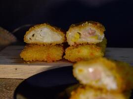 The Indonesian version of risoles is filled with mayonnaise, sausage, corn and boiled egg wrapped in a crepe-like wrapper and coated in breadcrumbs and deep-fried. selected focus. photo