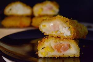 The Indonesian version of risoles is filled with mayonnaise, sausage, corn and boiled egg wrapped in a crepe-like wrapper and coated in breadcrumbs and deep-fried. selected focus. photo