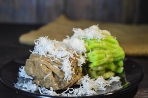 Textured, made from processed cassava that is steamed and mashed. Served with grated coconut. photo