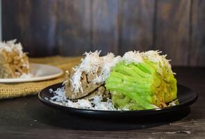 Textured, made from processed cassava that is steamed and mashed. Served with grated coconut. photo