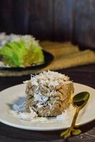 Textured, made from processed cassava that is steamed and mashed. Served with grated coconut. photo