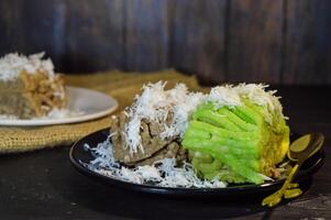 Textured, made from processed cassava that is steamed and mashed. Served with grated coconut. photo