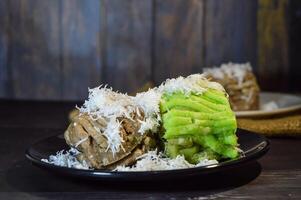 Textured, made from processed cassava that is steamed and mashed. Served with grated coconut. photo