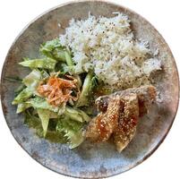 Enjoy crispy carp bites glazed with sweet chili sauce, served alongside fluffy quinoa rice and a refreshing green salad topped with carrots and sesame seeds. Perfect for a balanced meal. photo