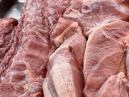 close up of raw pork meat on the market counter photo