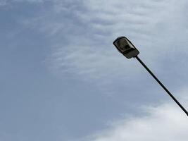 street light pole isolated on blue sky background photo