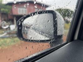 car window with rain drops photo