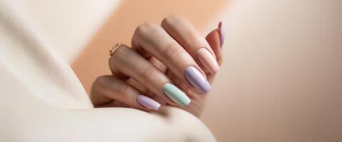 Woman hand with trendy minimalist pastel color block nail design photo