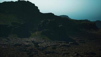 A very large mountain with some rocks on top of it video