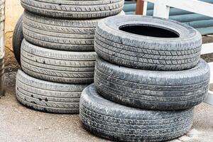 Stack of Worn Tires Outside photo