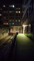 Prague, Czech republic - October 13, 2023. A red package pickup DPD box standing against a wall at night photo