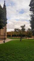Kutna Hora, Czech republic - October 28, 2023. Visitors enjoying a peaceful walk in a scenic autumn park of the Saint Barbaras Church. Vertical mobile photo. sstkvertical photo