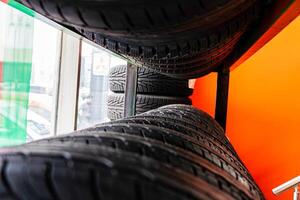 Stacked Tires in a Tire Shop Window photo