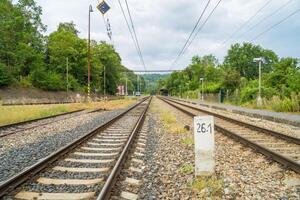 Railway lines with track ballast. Train tracks underlay, rails and crushed stone photo