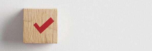 Wooden Block with Red Checkmark Symbol on White Background with Copy Space photo