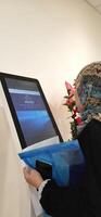Modern self check in machine for patient registration in hospitals. Makassar, South Sulawesi, Indonesia - August 12 2024 photo