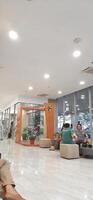 Atmosphere of patient queues to receive medical services at waiting area hospital. Makassar, South Sulawesi, Indonesia - August 12 2024 photo
