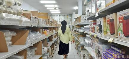 Coang supermarket shelf display. One of the complete cake and food equipment and ingredients stores in Makassar. South Sulawesi, Indonesia - August 7 2024 photo