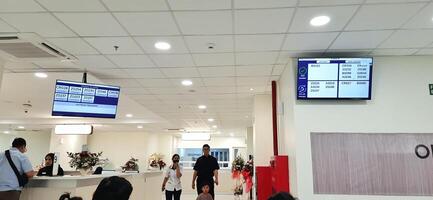 Atmosphere of patient queues to receive medical services at waiting area hospital. Makassar, South Sulawesi, Indonesia - August 12 2024 photo