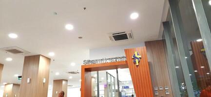 Atmosphere of patient queues to receive medical services at waiting area hospital. Makassar, South Sulawesi, Indonesia - August 12 2024 photo