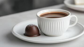 Cup of hot chocolate with marshmallows on white plate on white table, closeup photo