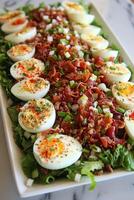 Fresh Green Salad with Crispy Bacon, Sliced Hard-Boiled Eggs, and Chopped Green Onions photo