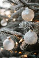 Sparkling Silver Ornaments on a Frosted Evergreen Tree, Creating a Magical Holiday Ambiance photo