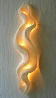 Abstract, Decorative White Wavy Wave-Pattern Home Decor With Embedded Lighting On Textured Wall photo
